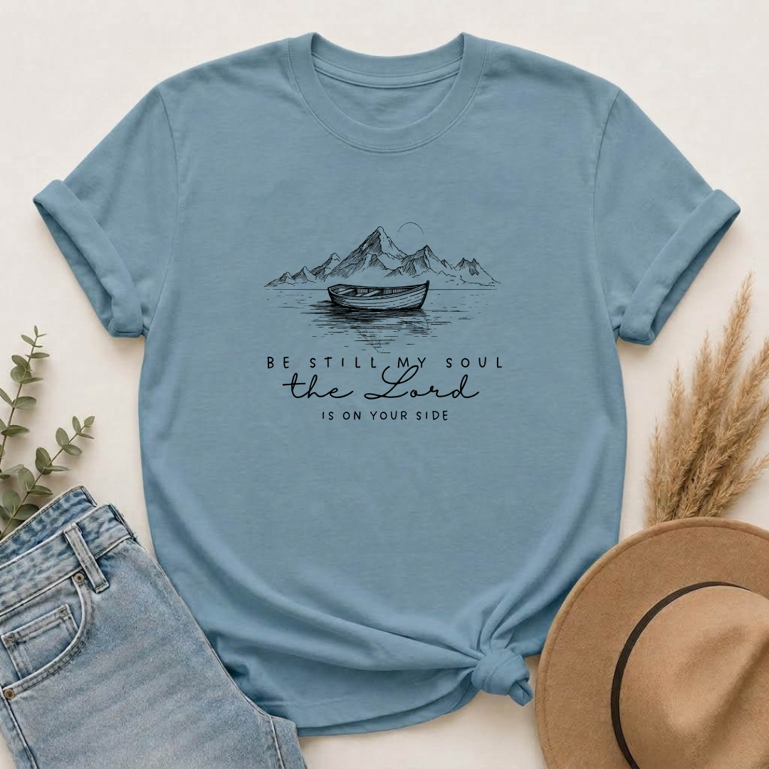 T-Shirt – “Be Still My Soul, the Lord Is On Your Side” Boat & Mountains Faith Tee